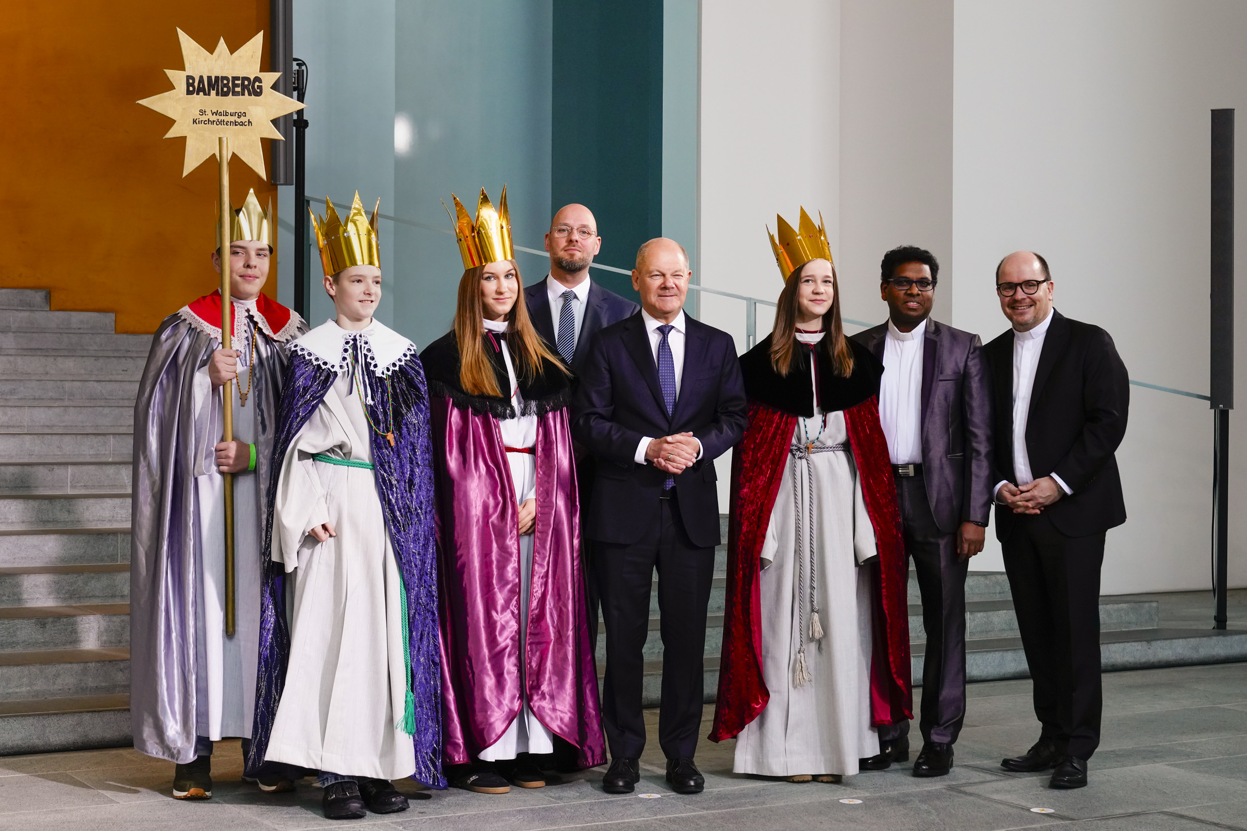 Mia, Franziska, Kilian, Aaron und Begleiter Ashok Antoni Mathew aus Kirchröttenbach vertraten das Erzbistum Bamberg beim Sternsingerempfang. Zum Gruppenfoto mit dem Kanzler stellten sie sich gemeinsam mit Dirk Bingener, Präsident des Kindermissionswerks ‚Die Sternsinger‘, und BDKJ-Bundespräses Stefan Ottersbach im Bundeskanzleramt auf.